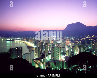 Looking down from high above seaside resort sunset at dusk high rise seafront hotels along Playa de Levante beach Benidorm Alicante Costa Blanca Spain Stock Photo