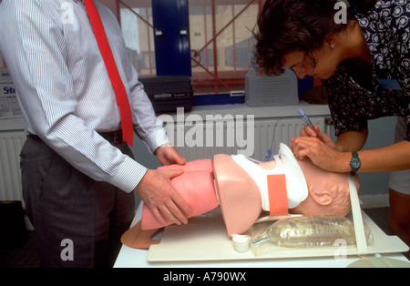 A photograph of a candidate on an advanced trauma life support (ATLS) course carrying out intubation training on a resus dummy. Stock Photo
