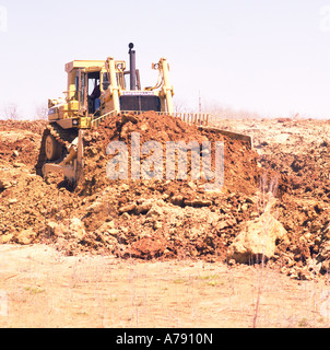 Caterpillar D10 bulldozer at a construction site clearing ground for a development of new homes Stock Photo