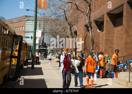CHICAGO Illinois Students on sidewalk outside Latin High School Old Town neighborhood male student walk and use cell phone Stock Photo