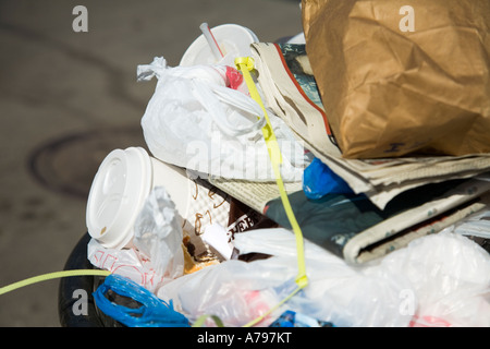 CHICAGO Illinois Garbage and trash piled in bin on sidewalk Old Town neighborhood Stock Photo