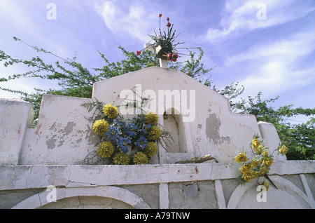 Flowers adorn a mausoleum  in cemetery in  Curacao Netherland Antilles Stock Photo