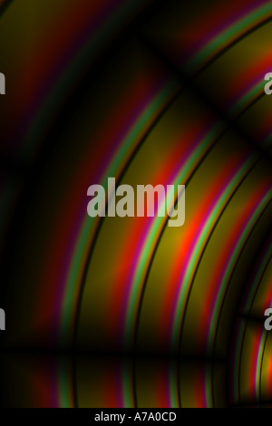 red, purple and green spiral pattern of light on computer ribbon cable Stock Photo