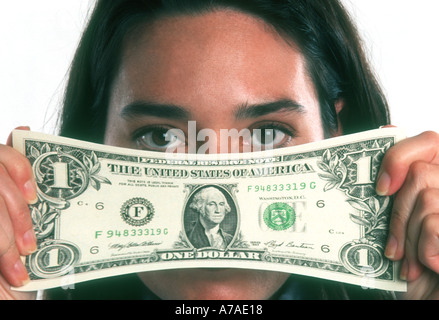 young woman stretching a one dollar bill US abstract Stock Photo