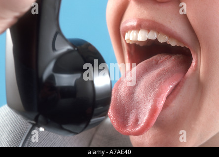 young woman yelling at telephone Stock Photo