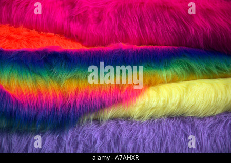 Rolls of coloured fabric for sale on a market stall Stock Photo