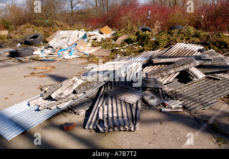 Rubbish left by caravan travellers dumped in car park of disused factory Newport South Wales UK Stock Photo