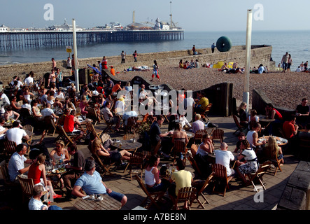 Visitors enjoy food and drink at the OHSO bar on Brighton beach Stock Photo