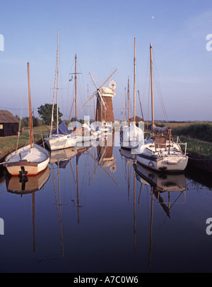 Horsey Staithe windpump drainage windmill Grade II listed building on Broads waterways moored boats reflected in still water Norfolk East Anglia UK Stock Photo