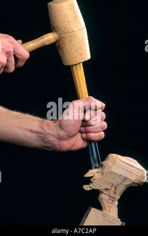 Puppet being carved from wood Stock Photo