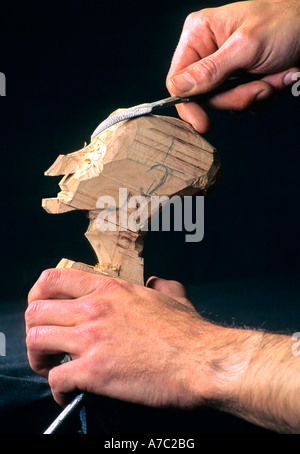 Puppet being carved from wood Stock Photo