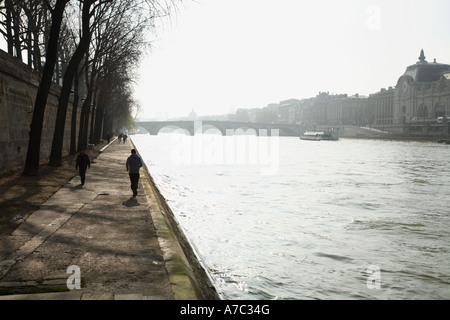 Promenade on the banks of the River Seine in the nearby of the Tuileries garden Paris France, Europe. people is jogging