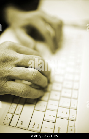 Hand working on a Laptop notebook computer keyboard Stock Photo