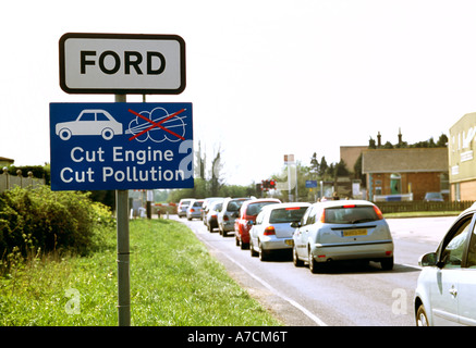 Cut Engine Cut Pollution sign and traffic queue, Ford, West Sussex, England, UK. Stock Photo