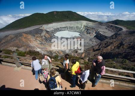 Visitors at railed platform enjoying view of the cone of Poas Volcano caldera in the Republic of Costa Rica in Central America Stock Photo