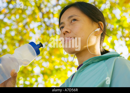 Young female with water bottle and MP3 player Stock Photo