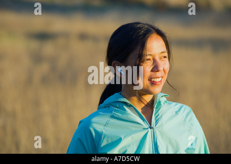 Young woman listening to headphones outdoors Stock Photo