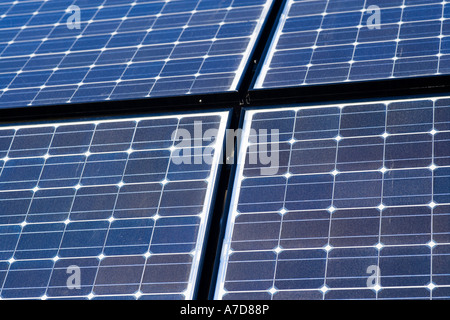 Array of solar panels producing electricity. Rows of monocrystalline photovoltaic solar cells. Stock Photo