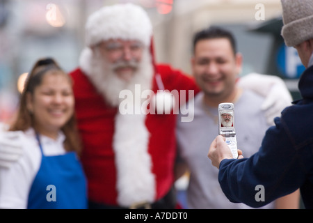 Latino couple posing with Santa Claus Stock Photo
