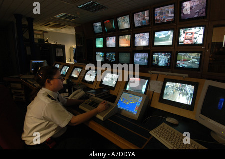 A CCTV operator at Brighton police station controls a bank of screens showing images from CCTV  cameras monitoring the streets Stock Photo