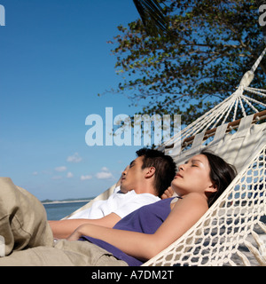 Couple in hammock on beach Stock Photo