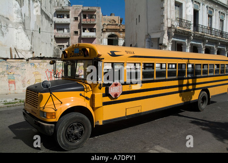 Yellow school bus driving along Prado Avenue in Havana, Cuba. Stock Photo