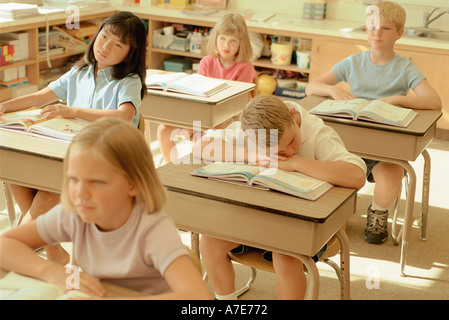 Boy sleeping in school classroom Stock Photo