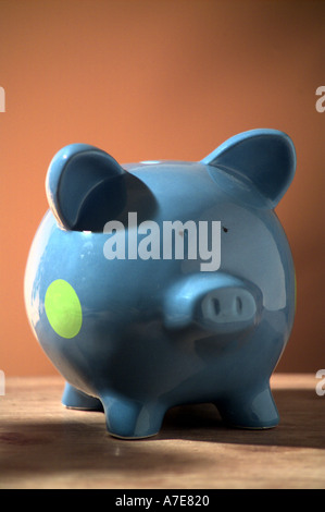 blue piggy bank money box on brown background Stock Photo