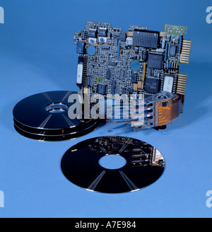 Dismantled hard disc drive assembly showing the read write head, disc cylinders and controller board. Stock Photo
