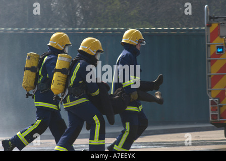 Fire recruits tackle a simulated road traffic accident as part of their passing out ceremony UK Stock Photo