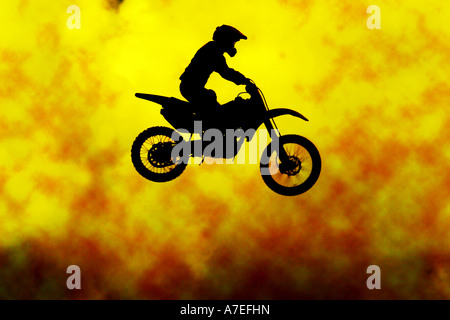 Motocross man on motor bike jumping over fire Stock Photo
