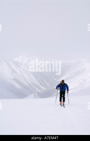 Skier skinning up the Asulkan Glacier Rogers Pass area Selkirk Mountains Canadian Rockies British Columbia Canada Stock Photo