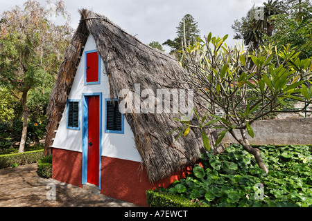 A typical house in the Santana style with a straw covered roof in the botanical garden, Funchal, Madeira, Portugal Stock Photo