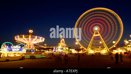 Fun fair with chairoplane and Ferris wheel Stock Photo