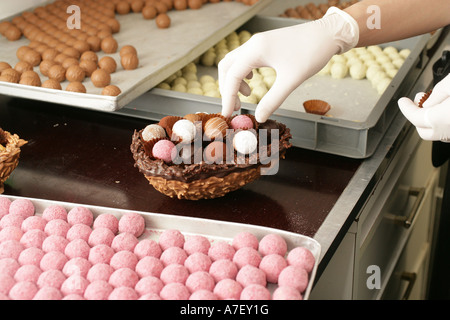 Easter eggs made of chocolate are filled with truffles in a confectionery Stock Photo