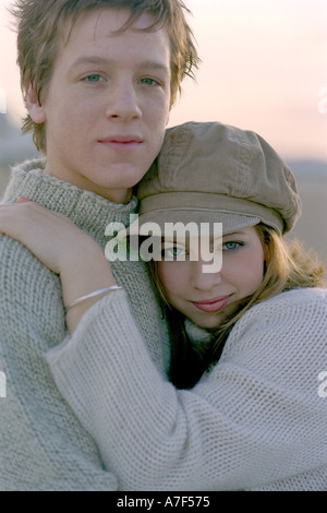 Young teenage couple in embrace on beach Stock Photo