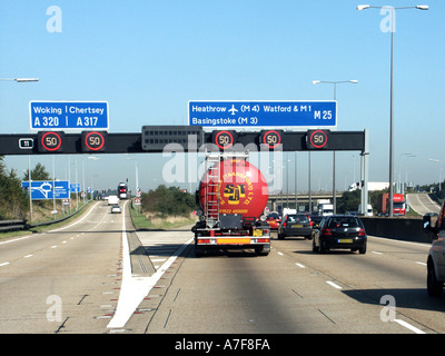 M25 motorway junction 11 slow moving traffic obscured number plates variable speed signs on London orbital highway Surrey England UK Stock Photo