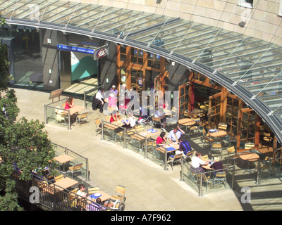 Aerial view looking down from above on group of people eating out alfresco at cafe bar in Milton Keynes shopping centre Buckinghamshire England UK Stock Photo