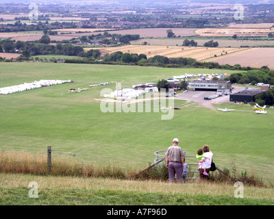 Looking down from high up on Dunstable Downs people watching gliders taking off from grass airfield below near Dunstable Bedfordshire England UK Stock Photo