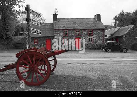 A traditional cart outside Molly Gallivan's cottage and tea room, Co. Kerry, Ireland. (Shown in red and monochrome) Stock Photo