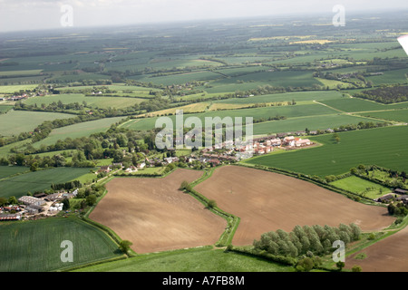 High level oblique aerial view north east of small village fields clouds in Essex north east of Saffron Walden England UK Stock Photo