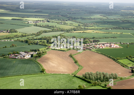 High level oblique aerial view north east of small village fields clouds in Essex north east of Saffron Walden England UK Stock Photo