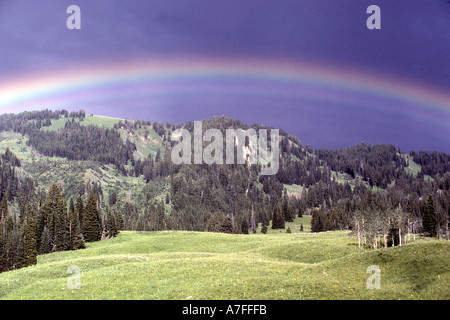 Rainbow over the summer green hills of the Gros Ventre Wilderness in the Gros Ventre mountains of Wyoming Stock Photo
