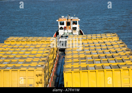 Tug boat towing waste containers down The Thames London United Kingdom Stock Photo
