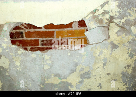 Plaster chipping off brick building Stock Photo