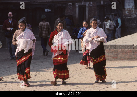 Young women in Kathmandu on their way to make offerings to the gods Stock Photo