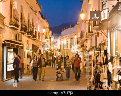 Tourists shopping at dusk in Nerja Spain Stock Photo