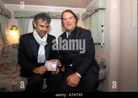 Blind Italian tenor Andrea Bocelli hands Welsh bass baritone Bryn Terfel a copy of Bryns new CD at the 2005 Faenol Festival Stock Photo