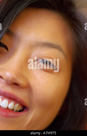 close up portrait of beautiful young Korean oriental female smiling with pink lips Stock Photo