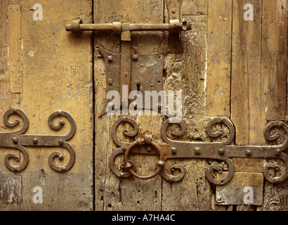 Iron lock on wooden door of the 13th Century church of St Jacques at Villefranche de Conflent in the Pyrenees Orientales, France Stock Photo